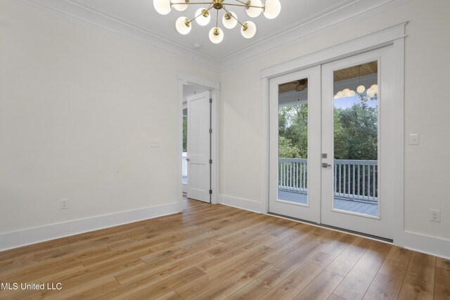 doorway with a notable chandelier, light wood finished floors, french doors, and crown molding