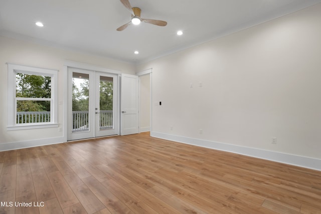 spare room featuring french doors, ceiling fan, ornamental molding, and light wood-type flooring