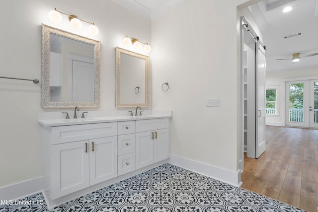 bathroom featuring vanity, wood-type flooring, and ornamental molding