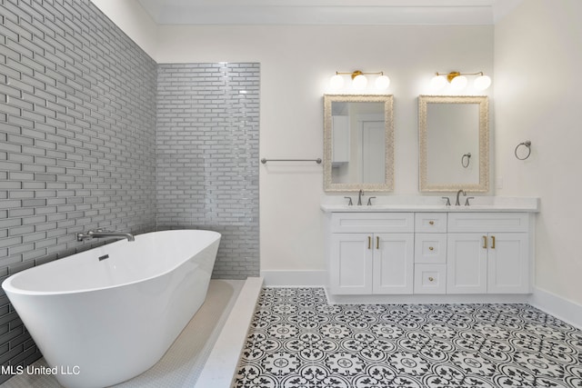 bathroom with tile walls, vanity, tile patterned flooring, and a bathing tub