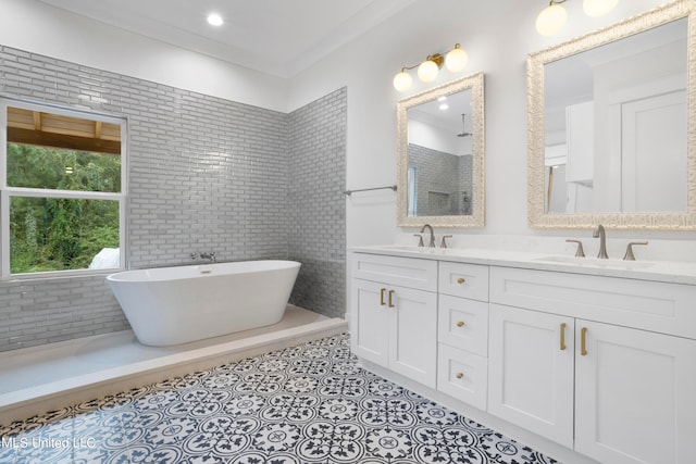 bathroom with separate shower and tub, tile patterned floors, tile walls, vanity, and crown molding