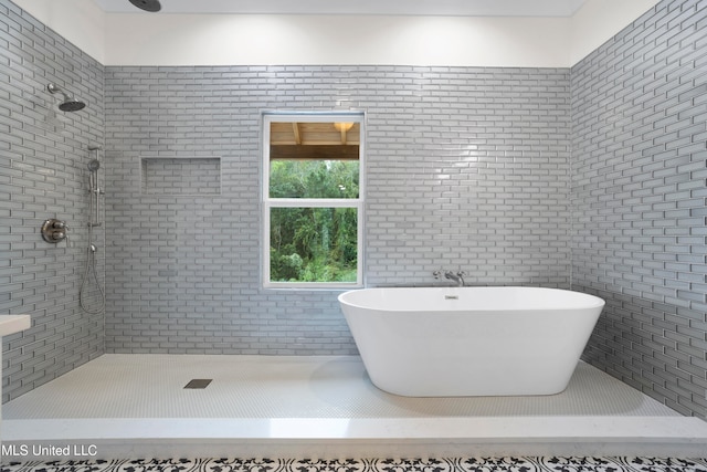 bathroom featuring tile walls and plus walk in shower