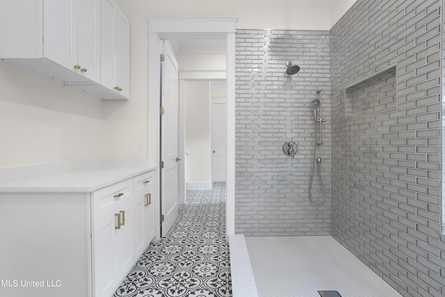 full bath featuring tile patterned flooring and a tile shower