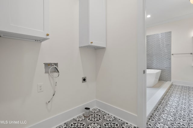 laundry room featuring cabinets, hookup for a washing machine, light tile patterned floors, and electric dryer hookup