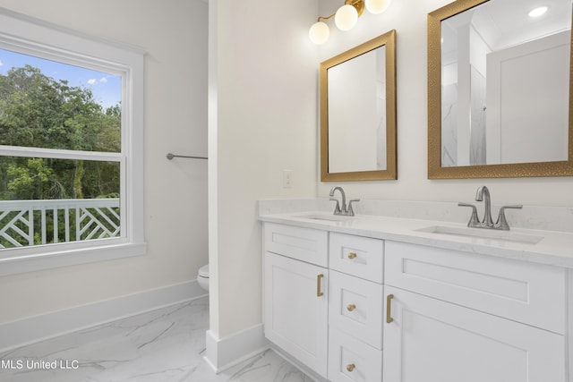 full bathroom featuring baseboards, marble finish floor, toilet, and a sink