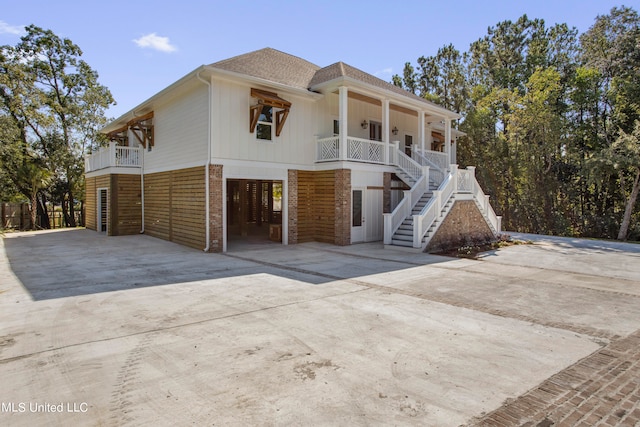 view of front of property featuring covered porch and a carport