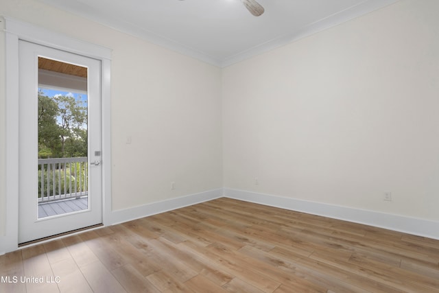 spare room with crown molding and light wood-type flooring