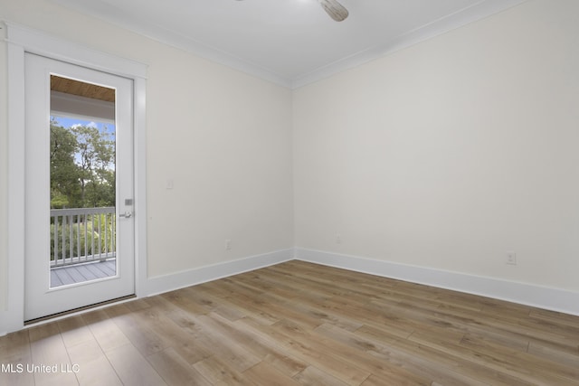 unfurnished room featuring light wood-type flooring, baseboards, and ornamental molding