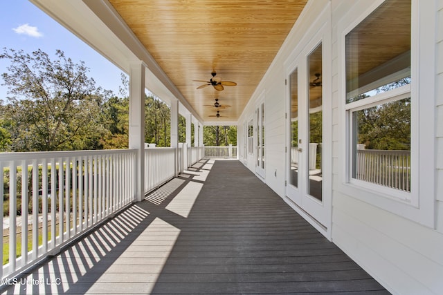 wooden terrace featuring french doors and ceiling fan