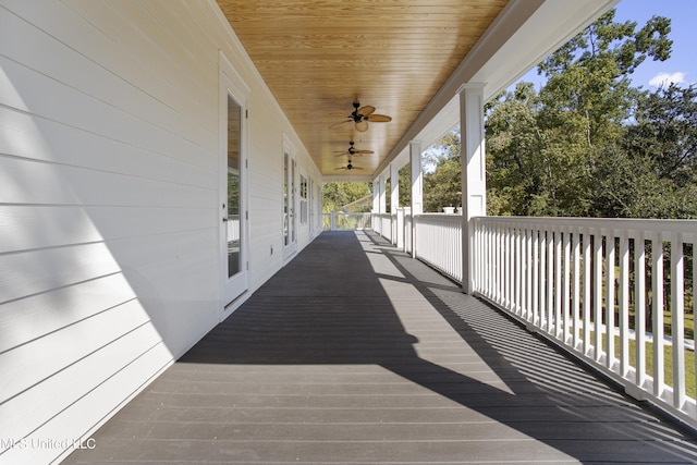 wooden terrace featuring a ceiling fan