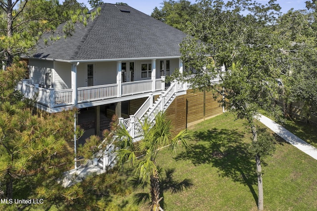 rear view of property with a yard, stairs, a shingled roof, and covered porch