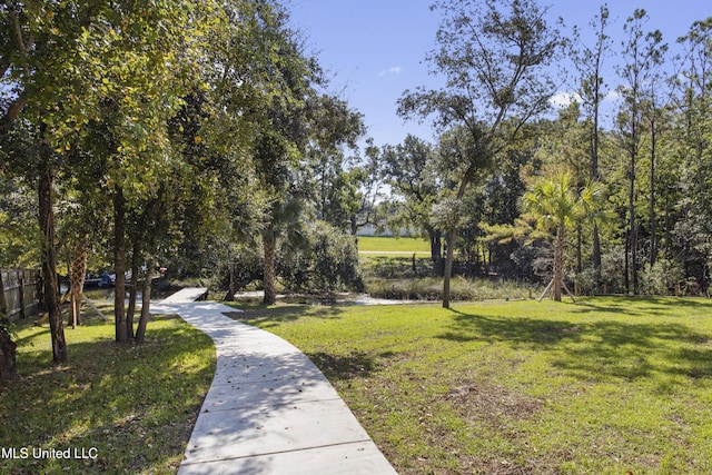 view of home's community featuring a yard and fence