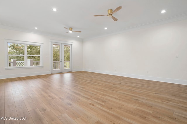 empty room with light hardwood / wood-style floors, french doors, ornamental molding, and ceiling fan