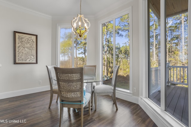 dining area with an inviting chandelier, baseboards, crown molding, and dark wood-type flooring