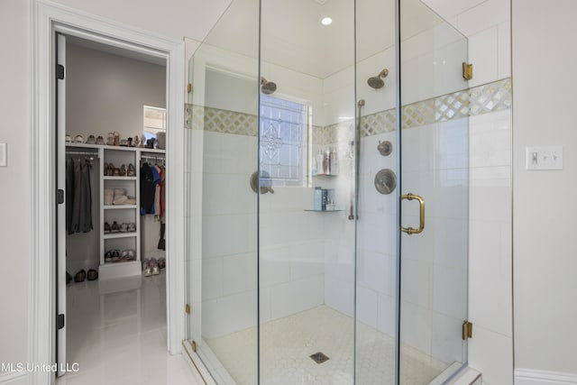 bathroom featuring a stall shower and a spacious closet