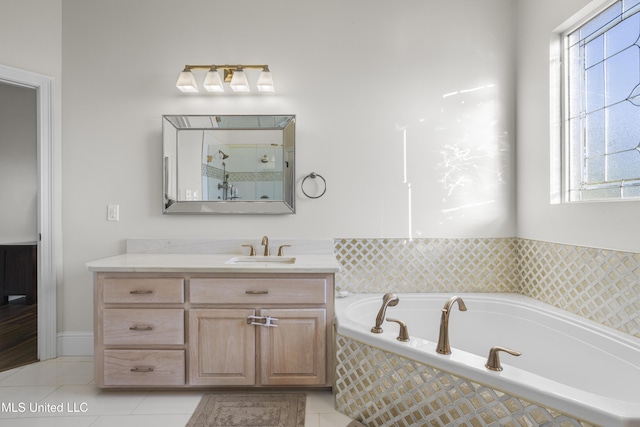 full bathroom featuring tile patterned floors, walk in shower, a garden tub, and vanity
