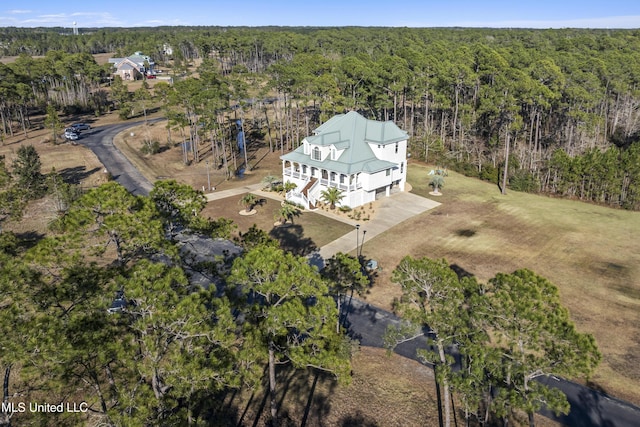 bird's eye view with a wooded view