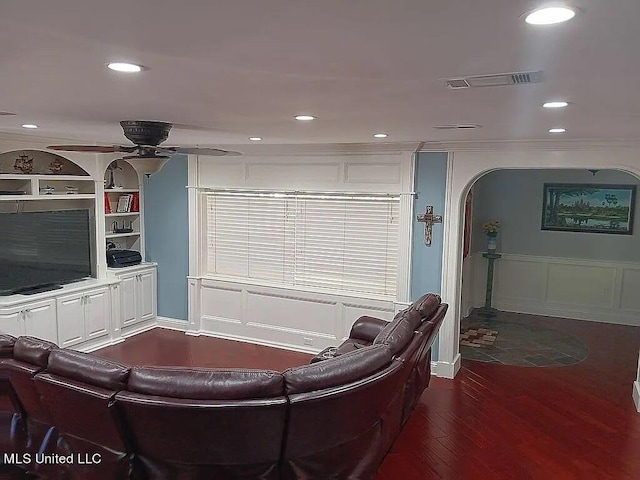 living room with crown molding, ceiling fan, and dark hardwood / wood-style flooring