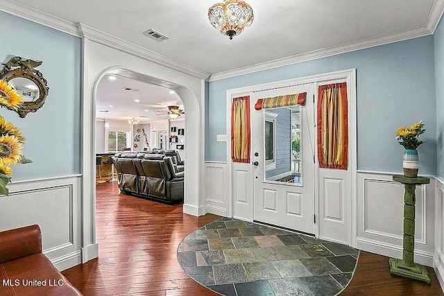 entrance foyer featuring ceiling fan, crown molding, and dark hardwood / wood-style floors