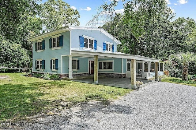 view of front of property with a porch and a front lawn