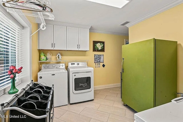 laundry room with ornamental molding, independent washer and dryer, and cabinets