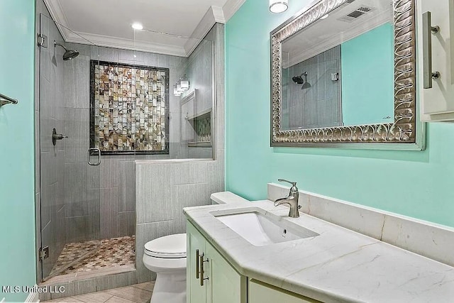 bathroom with vanity, toilet, walk in shower, and ornamental molding