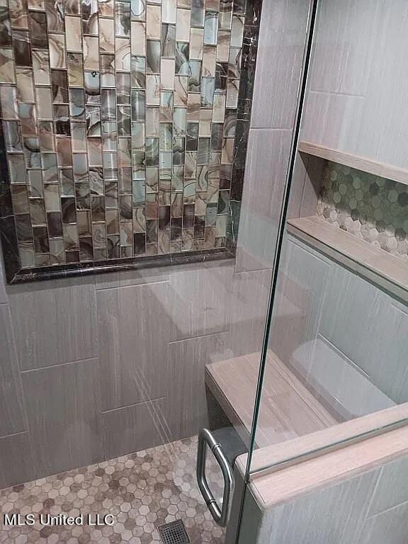 bathroom with a shower with shower door