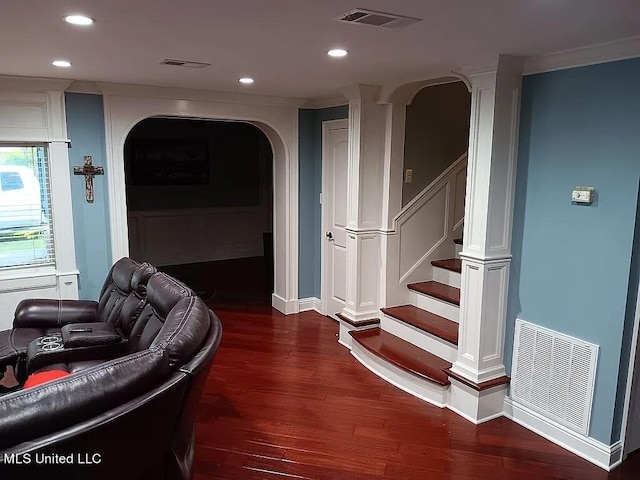 living room with ornamental molding and dark hardwood / wood-style floors