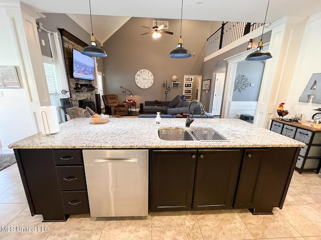 kitchen with hanging light fixtures, sink, and a center island with sink