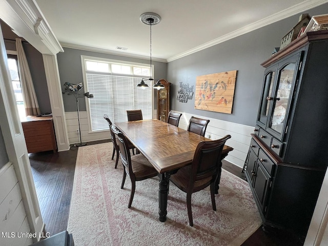 dining room featuring crown molding and dark hardwood / wood-style flooring