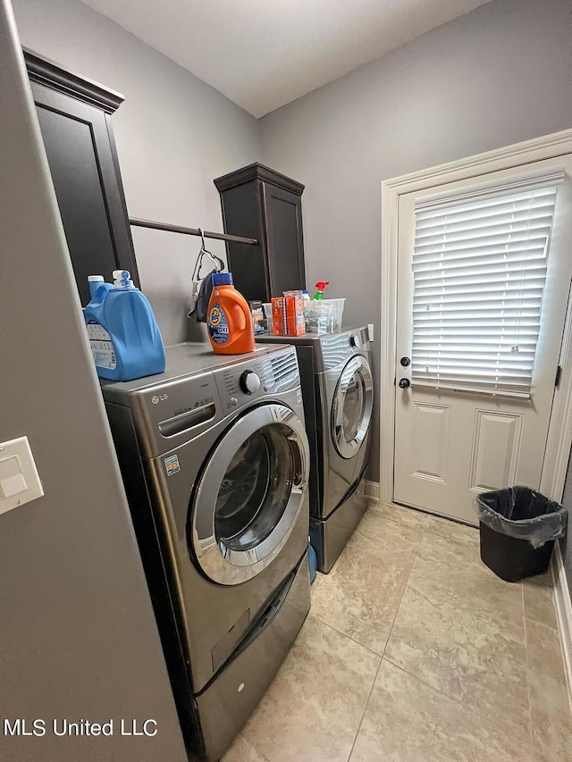 laundry room featuring cabinets and separate washer and dryer