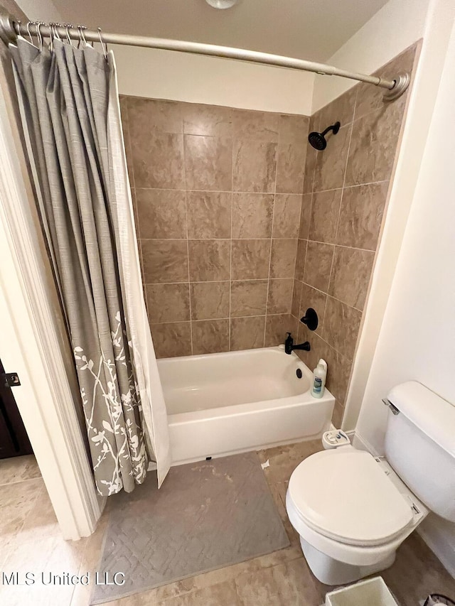 bathroom featuring shower / tub combo and toilet