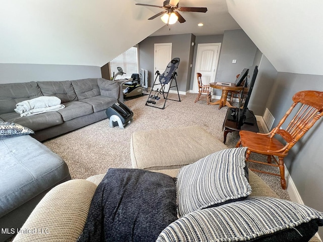 carpeted living room with ceiling fan and vaulted ceiling