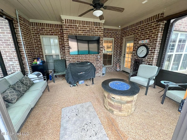 view of patio featuring ceiling fan and an outdoor living space with a fire pit