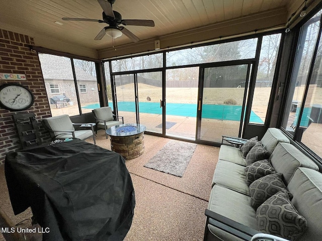 sunroom / solarium featuring wooden ceiling and ceiling fan