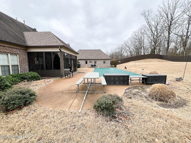 view of pool featuring a patio area and a sunroom