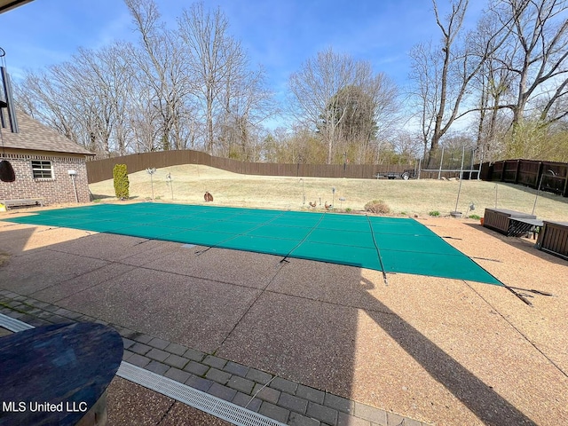 view of swimming pool featuring a patio and a lawn