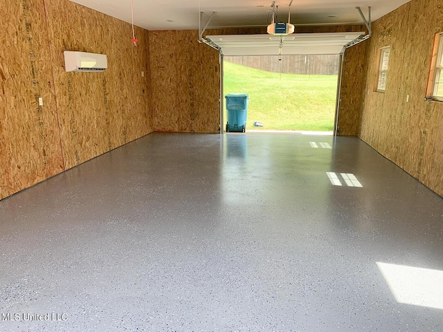 garage with a garage door opener, wooden walls, and an AC wall unit