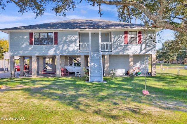 3323 Bay Shore Dr, Diberville, MS 39540 - back of house featuring a yard, a garage, a carport, and a patio area