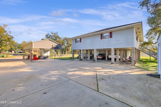 back of house with a carport