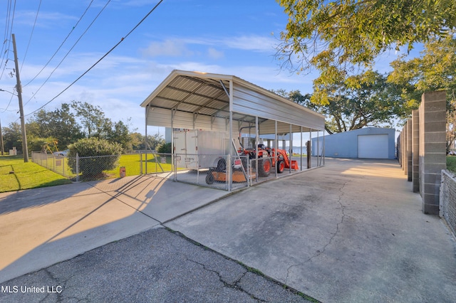 view of outbuilding with a carport, a garage, and a yard