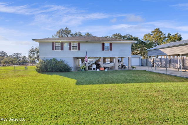 view of front of property with a front yard, a garage, a carport, and an outdoor structure