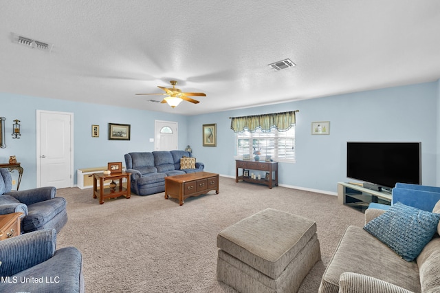 carpeted living room with ceiling fan and a textured ceiling