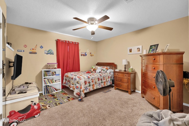 carpeted bedroom with ceiling fan and a textured ceiling