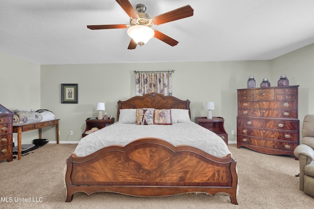 bedroom with ceiling fan, light colored carpet, and a textured ceiling