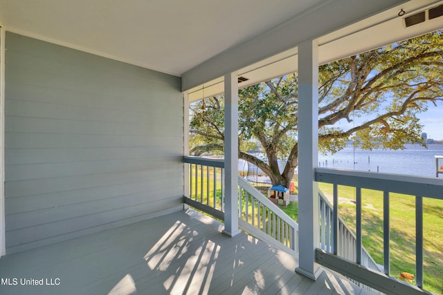 wooden deck featuring a yard and a water view