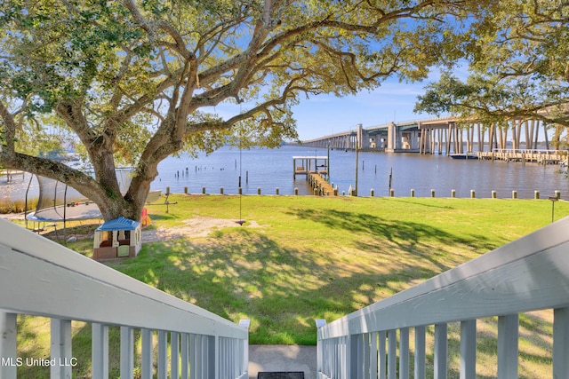 view of yard featuring a boat dock and a water view