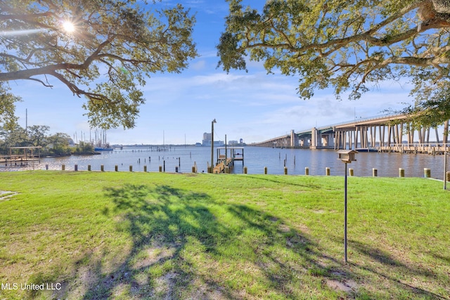 view of yard with a dock and a water view