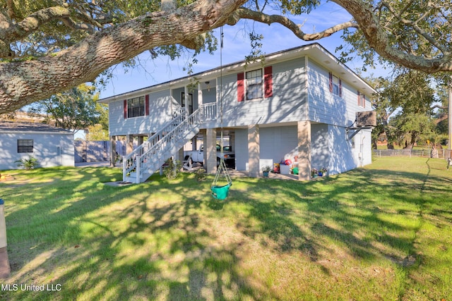 back of property featuring a yard and a garage