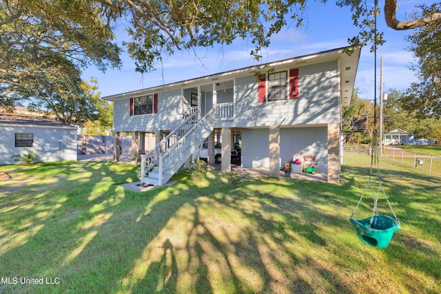 view of front of house featuring a garage and a front lawn